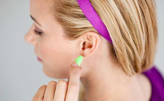 Woman putting in ear plugs