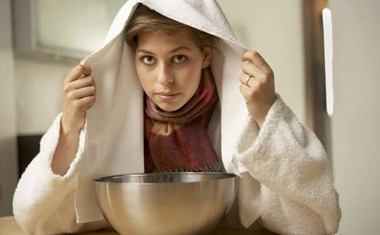 Natural remedies for coughs and colds: Woman inhaling steam