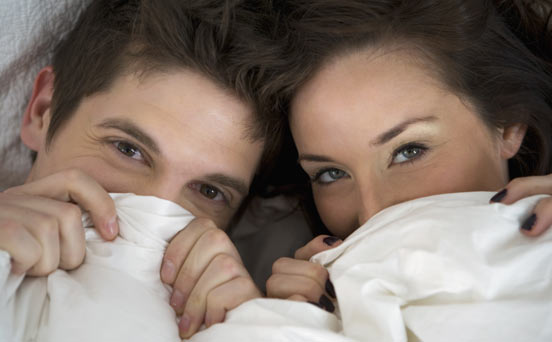 Couple hiding under sheets
