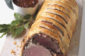 A delicious roast filet of beef wrapped in a crusty puff pastry. It is served with a rich red wine sauce