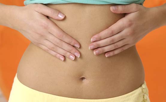 Anti-bloating diet - woman with hand on stomach