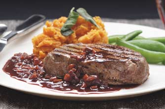 A rich red wine sauce is served with pan fried fillet steak. This steak is moist, tender and very tasty. A rich red wine sauce is served with pan fried fillet steak. This steak is moist, tender and very tasty.