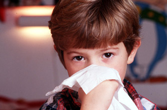 Boy with tissue: Keeping children safe from flu