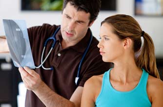 Woman and doctor looking at a mammogram
