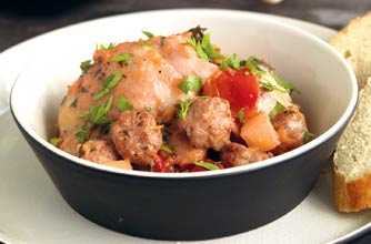 Sausage and chicken with apple and plums