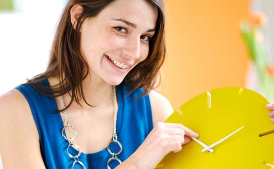 Woman holding a clock