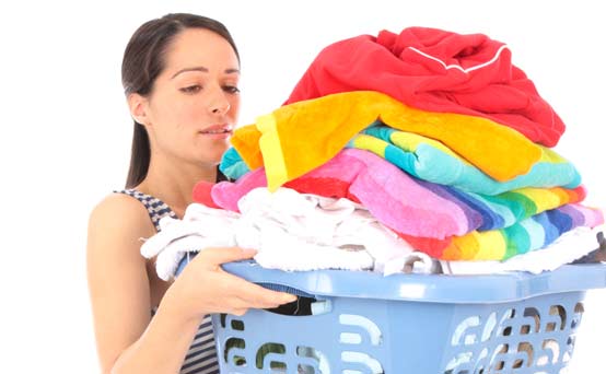 Woman carrying a pile of washing Woman carrying a pile of washing