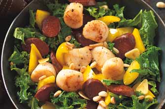 Scallops, kale, yellow pepper and Spanish chorizo are stir-fried in this delicious seafood dish. Pine nuts are added for crunch. Serve it as a starter or main and eat with bread, rice or potatoes