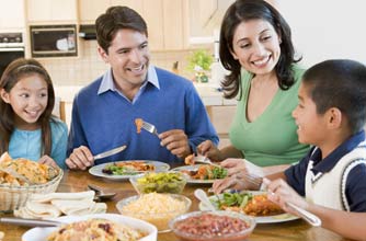 Family eating together at the dinner table Family eating together at the dinner table