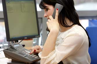 Teenage girl talking on the phone at work Teenage girl talking on the phone at work