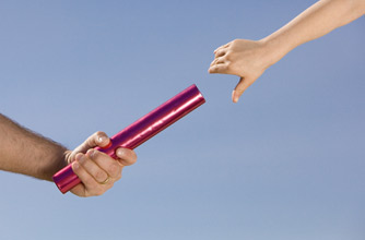 Father handing son baton Father handing son baton