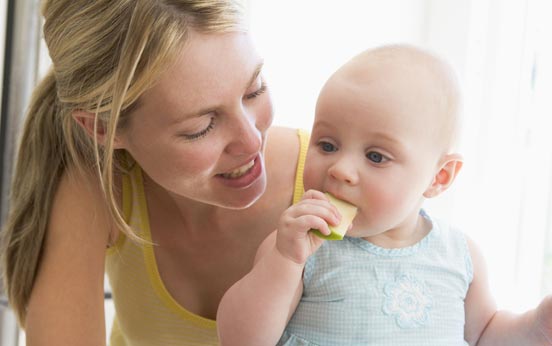 Weaning baby girl eating an apple Weaning baby girl eating an apple