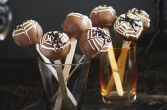 Chocolate cake on sticks. This is great party food for children and adults. The decoration is piped for Halloween, but you can decorate the pops to suit the occasion.