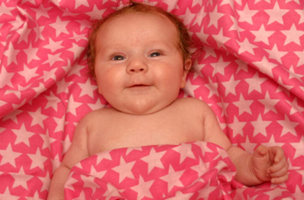 Smiling baby on a starry blanket