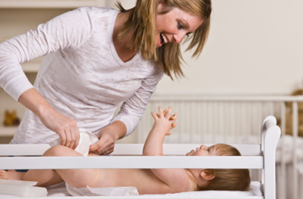 Mother changing her baby Mother changing her baby