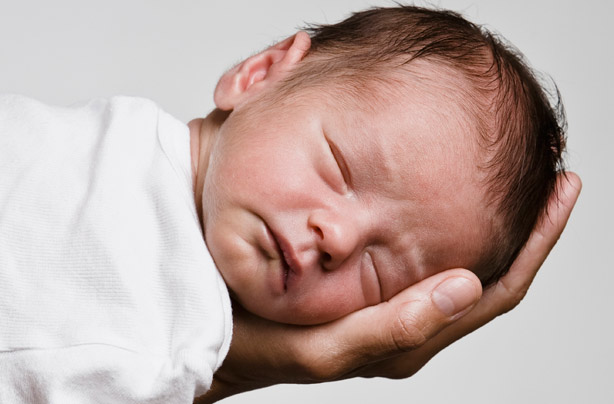 Cute baby sleeping in hands