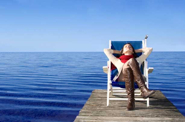 woman relaxing in deck chair woman relaxing in deck chair