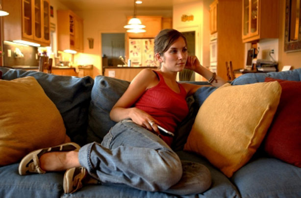 Woman watching TV alone Woman watching TV alone