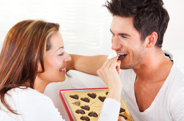 Couple feeding each other chocolates