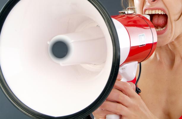 Woman shouting into megaphone