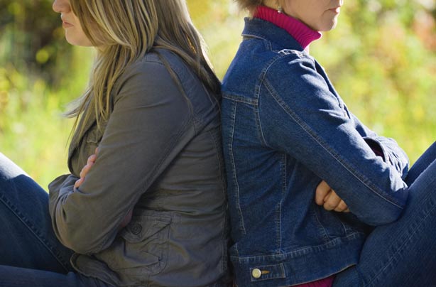 Teenage girl and mother back to back