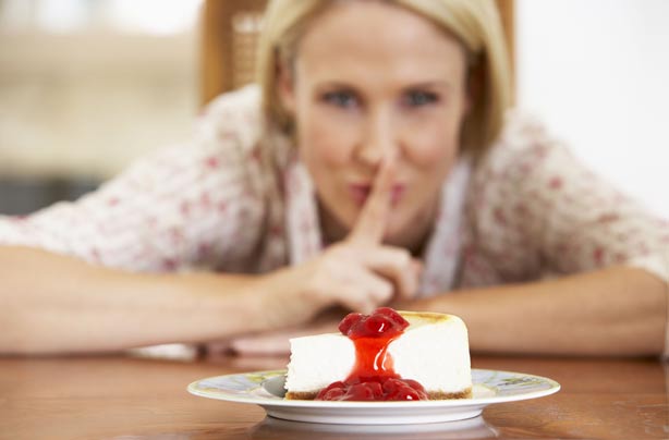 Woman tempted by cheescake Woman tempted by cheescake
