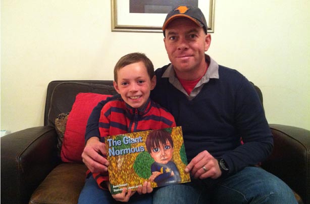 David Bennet with his son, Oliver, and the book, The Giant Normous