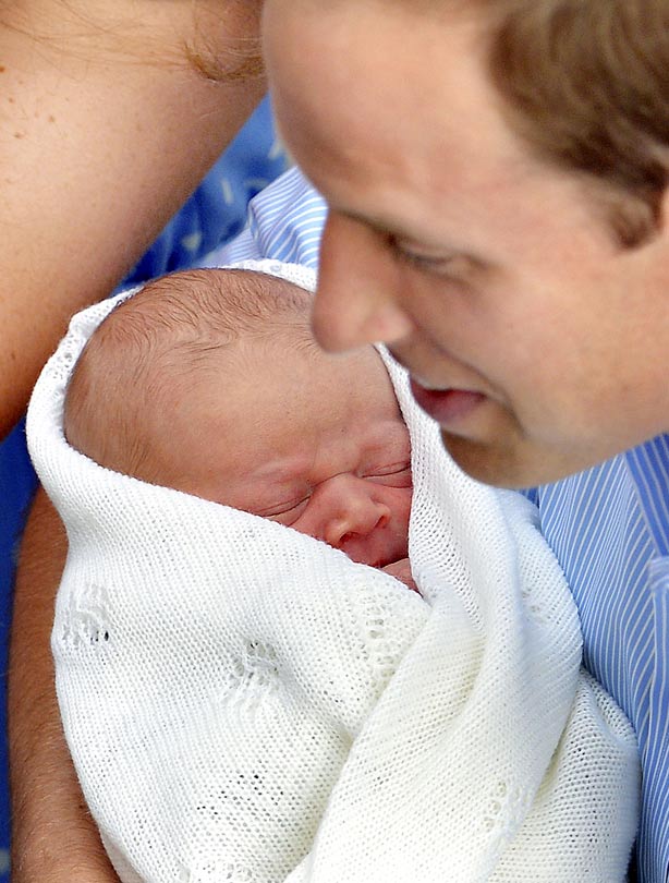 Prince William holding his baby son Prince William holding his baby son