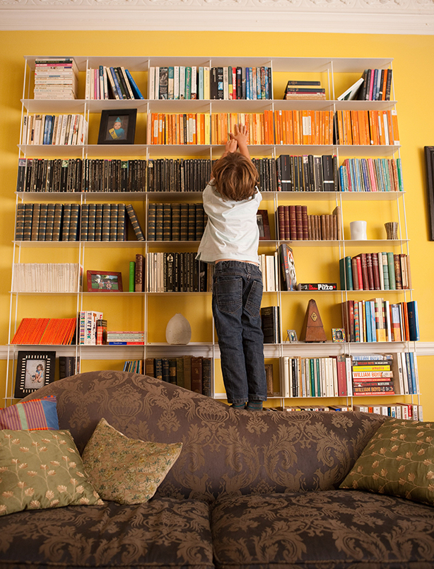 Boy climbing bookshelf Boy climbing bookshelf