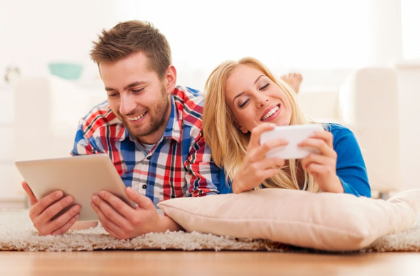 Man and woman using tablets, phones