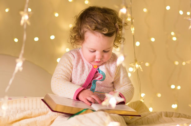 Little girl reading story book