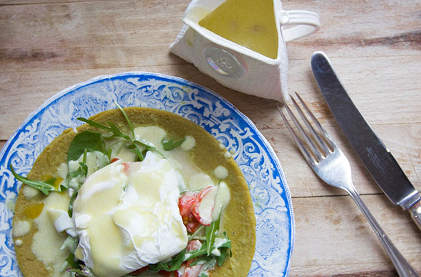 Poached eggs with tomato and rocket on a buckwheat pancake