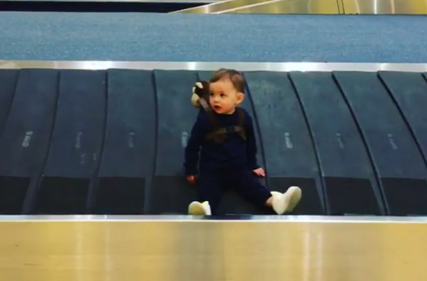 Adam Thomas' son Teddy on baggage carousel