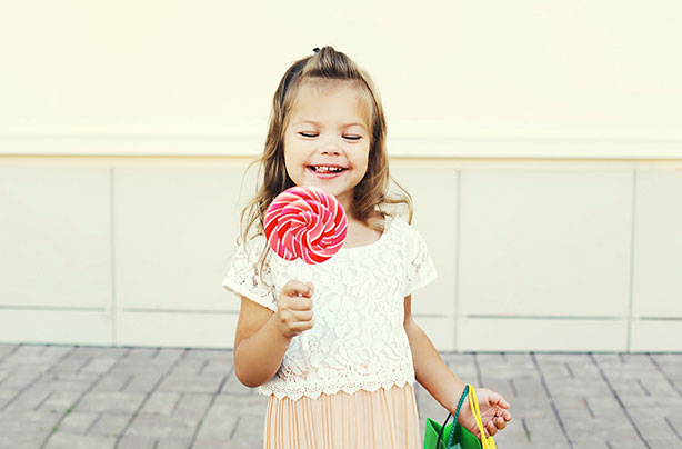 Sugar in children's food, little girl, lollipop