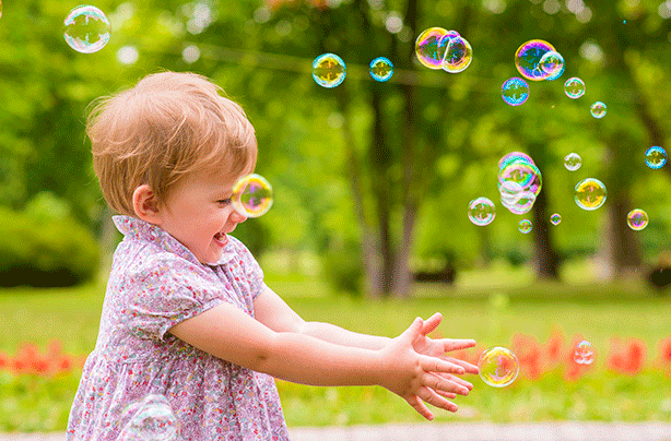 Girl playing with bubbles, baby games