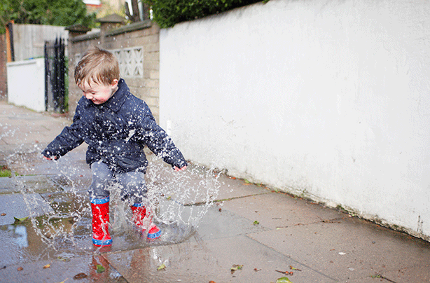 Activities for toddlers, boy jumping in puddles